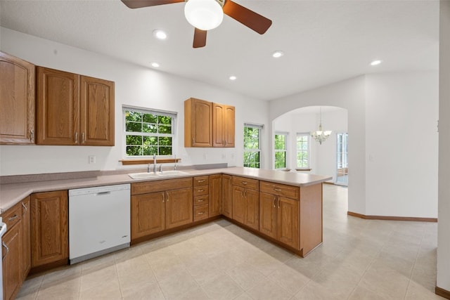 3017 Peaceful Dr, Riverside, IA 52327 - kitchen with dishwasher, a sink, arched walkways, brown cabinets, and a chandelier