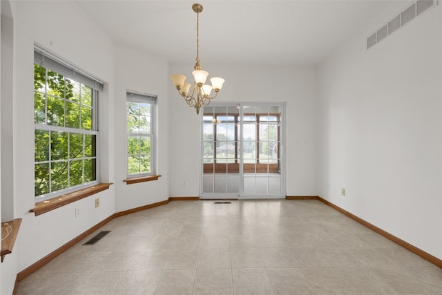 3017 Peaceful Dr, Riverside, IA 52327 - spare room with a chandelier, baseboards, and light tile patterned floors