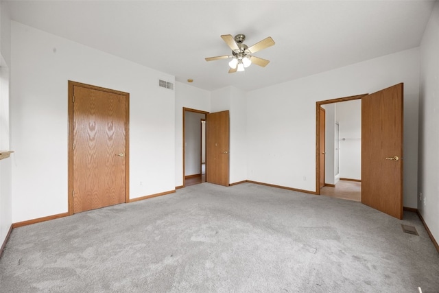 3017 Peaceful Dr, Riverside, IA 52327 - unfurnished bedroom featuring carpet, baseboards, and a ceiling fan