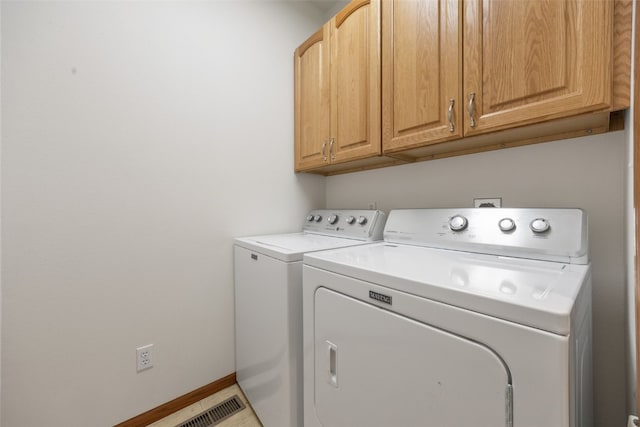 3017 Peaceful Dr, Riverside, IA 52327 - laundry area with cabinet space, separate washer and dryer, and baseboards