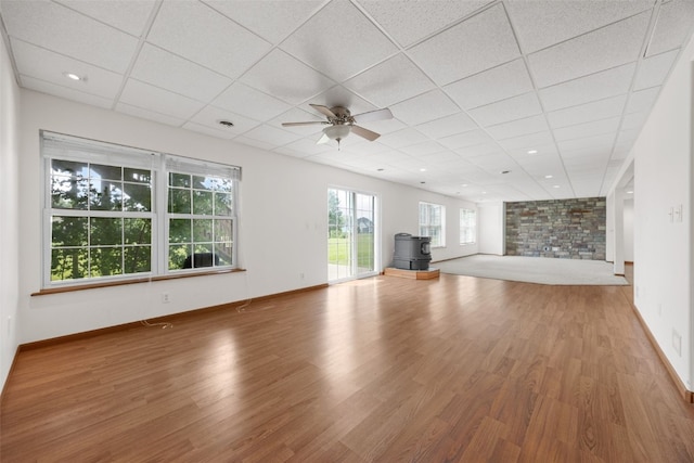 3017 Peaceful Dr, Riverside, IA 52327 - unfurnished living room featuring wood finished floors, a ceiling fan, a paneled ceiling, and baseboards