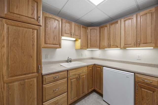 3017 Peaceful Dr, Riverside, IA 52327 - kitchen featuring white dishwasher, a sink, light countertops, and a paneled ceiling