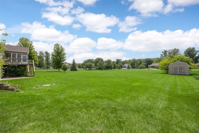3017 Peaceful Dr, Riverside, IA 52327 - view of grassy yard with stairway and a wooden deck