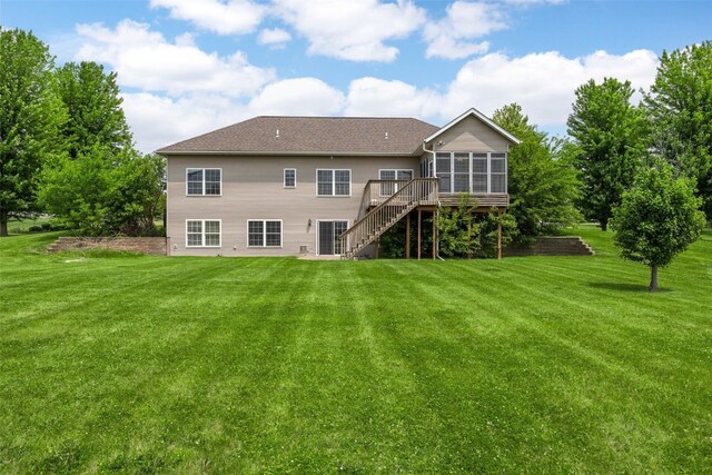 3017 Peaceful Dr, Riverside, IA 52327 - rear view of property with a sunroom, stairway, and a lawn