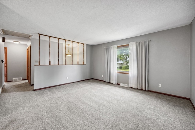 17 C Ave, Newhall, IA 52315 - empty room with carpet, a textured ceiling, and baseboards