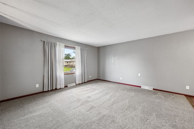 17 C Ave, Newhall, IA 52315 - carpeted empty room featuring a textured ceiling and baseboards