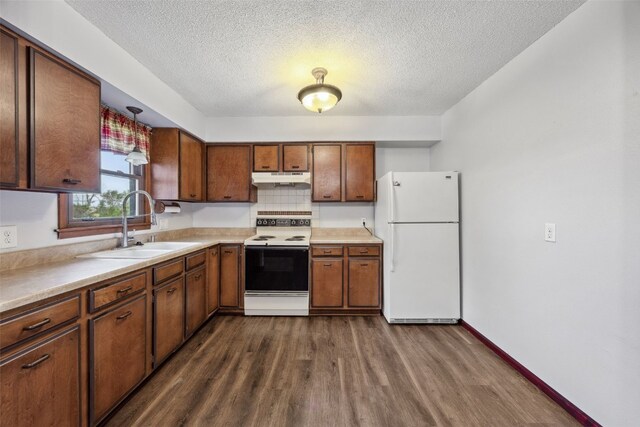 17 C Ave, Newhall, IA 52315 - kitchen featuring white appliances, under cabinet range hood, dark wood-style flooring, a sink, and a textured ceiling