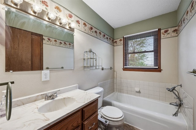 17 C Ave, Newhall, IA 52315 - bathroom with toilet, vanity, a bath, and a textured ceiling