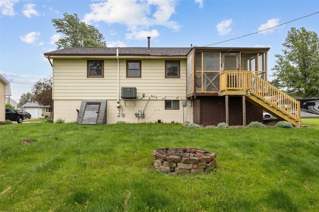 17 C Ave, Newhall, IA 52315 - rear view of property featuring an outdoor fire pit, a sunroom, stairway, a lawn, and brick siding