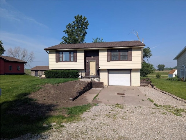 17 C Ave, Newhall, IA 52315 - split foyer home featuring concrete driveway, a garage, and a front lawn