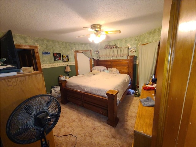 1114 2nd Ave, Vinton, IA 52349 - bedroom featuring carpet, a textured ceiling, ceiling fan, and wallpapered walls