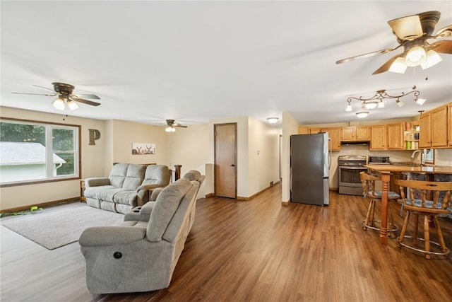 1805 4th Ave, South Amana, IA 52334 - living area with a ceiling fan, baseboards, and dark wood-type flooring