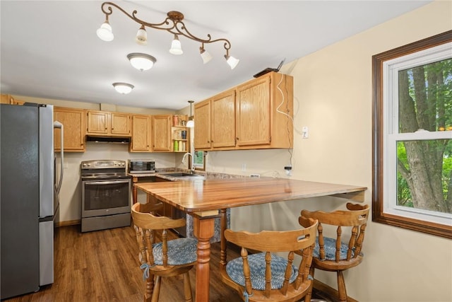 1805 4th Ave, South Amana, IA 52334 - kitchen featuring stainless steel appliances, a sink, under cabinet range hood, and healthy amount of natural light