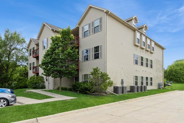 1080 Rachael St Unit 304, North Liberty, IA 52317 - view of property exterior featuring central AC and a lawn