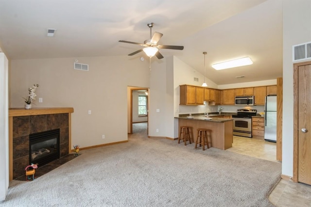 1080 Rachael St Unit 304, North Liberty, IA 52317 - kitchen featuring stainless steel appliances, a peninsula, open floor plan, dark countertops, and high vaulted ceiling