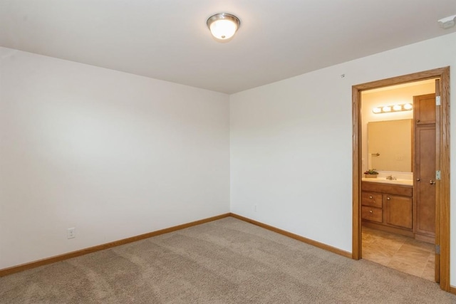 1080 Rachael St Unit 304, North Liberty, IA 52317 - spare room with light carpet, baseboards, and a sink