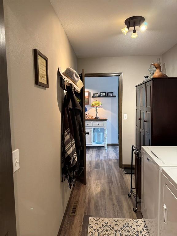 622 Prairie Hill Dr, Atkins, IA 52206 - hall with separate washer and dryer, dark wood-style floors, and baseboards