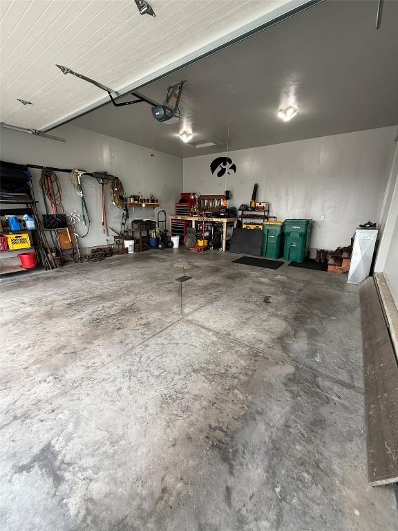 622 Prairie Hill Dr, Atkins, IA 52206 - garage featuring a workshop area and a garage door opener