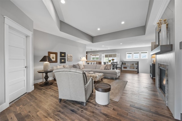 6318 Rapids Ridge Rd NE, Cedar Rapids, IA 52411 - living area with a warm lit fireplace, recessed lighting, and dark wood-style floors