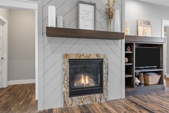 6318 Rapids Ridge Rd NE, Cedar Rapids, IA 52411 - detailed view of wood finished floors, baseboards, and a glass covered fireplace