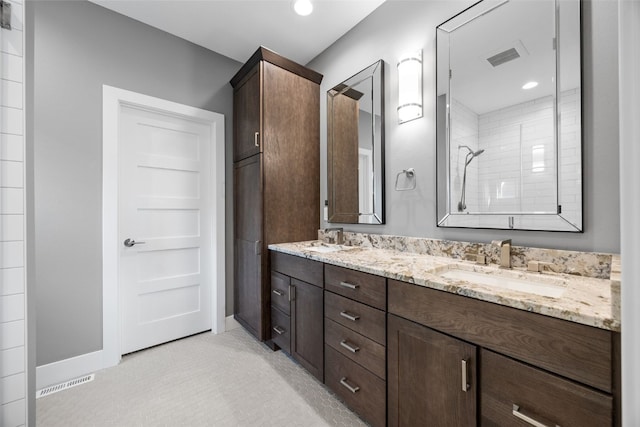 6318 Rapids Ridge Rd NE, Cedar Rapids, IA 52411 - bathroom featuring double vanity and a tile shower