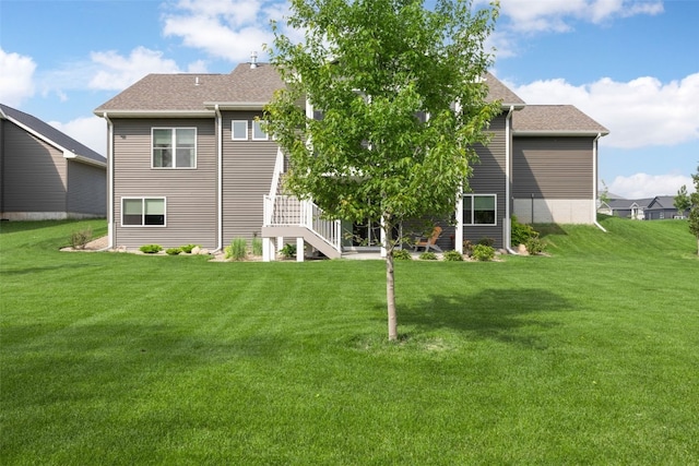 6318 Rapids Ridge Rd NE, Cedar Rapids, IA 52411 - back of property with a lawn, stairs, and roof with shingles