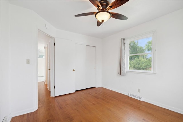 32 29th Ave SW, Cedar Rapids, IA 52404 - unfurnished bedroom featuring wood finished floors, baseboards, a closet, and a ceiling fan