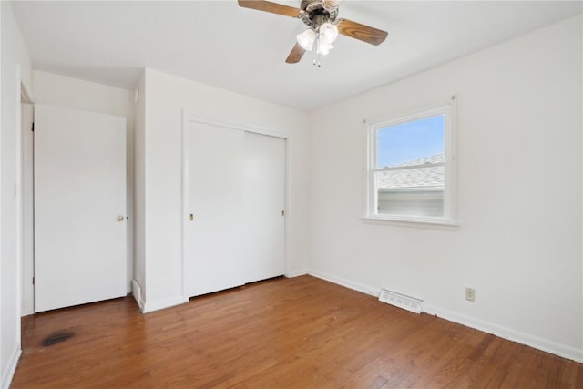 32 29th Ave SW, Cedar Rapids, IA 52404 - unfurnished bedroom featuring wood finished floors, baseboards, a closet, and ceiling fan