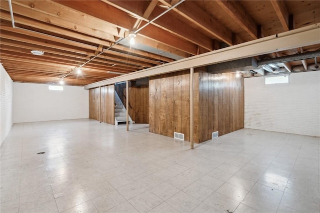 32 29th Ave SW, Cedar Rapids, IA 52404 - below grade area with stairway, tile patterned floors, and brick wall