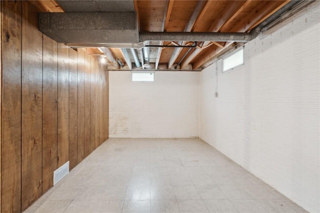 32 29th Ave SW, Cedar Rapids, IA 52404 - below grade area with brick wall, wood walls, and light floors