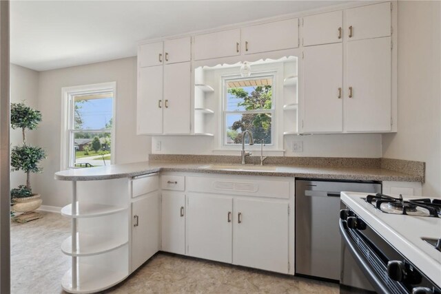 1252 29th St, Cedar Rapids, IA 52402 - kitchen with open shelves, white range with gas cooktop, a sink, and healthy amount of natural light