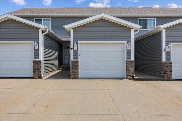 5937 Muirfield Dr SW Unit 2, Cedar Rapids, IA 52404 - view of front of home with concrete driveway, a garage, and brick siding