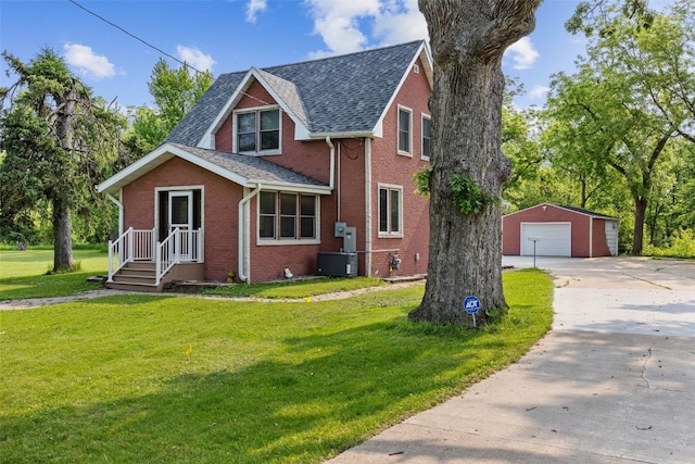 4427 J St SW, Cedar Rapids, IA 52404 - view of front of property with a garage, an outbuilding, brick siding, a front yard, and concrete driveway