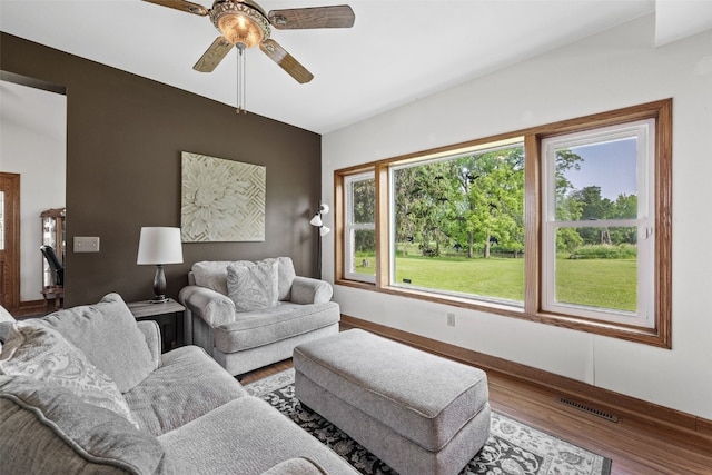 4427 J St SW, Cedar Rapids, IA 52404 - living room with wood finished floors, ceiling fan, and baseboards