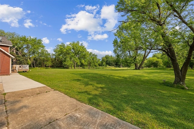 4427 J St SW, Cedar Rapids, IA 52404 - view of grassy yard featuring a deck
