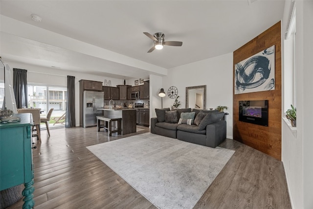 1221 Ronald Way, North Liberty, IA 52317 - living area featuring a ceiling fan, a large fireplace, and wood finished floors