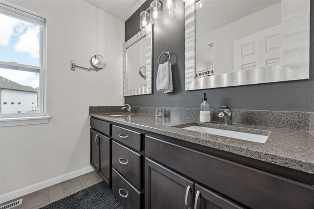 1221 Ronald Way, North Liberty, IA 52317 - bathroom with tile patterned flooring, double vanity, and baseboards