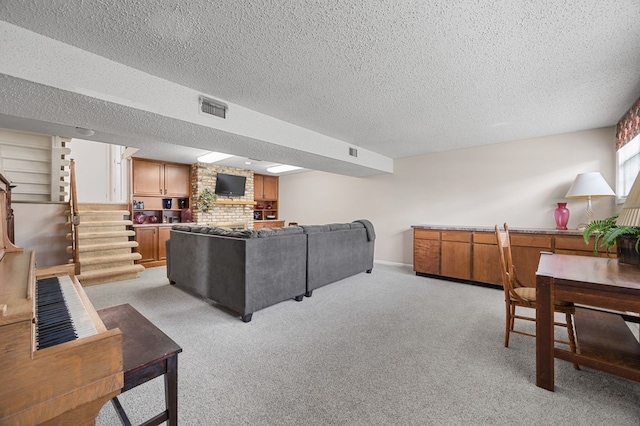 6909 Kent Dr NE, Cedar Rapids, IA 52402 - living area featuring a textured ceiling, stairs, and light colored carpet