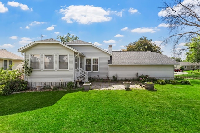 6909 Kent Dr NE, Cedar Rapids, IA 52402 - back of house with a lawn, a chimney, entry steps, and a shingled roof