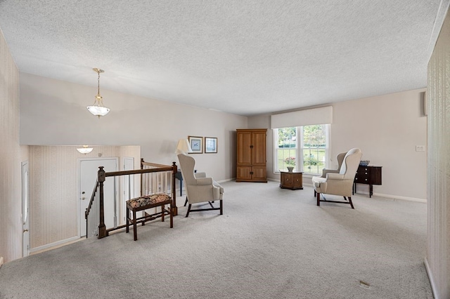 6909 Kent Dr NE, Cedar Rapids, IA 52402 - sitting room with an upstairs landing, carpet flooring, a textured ceiling, and baseboards
