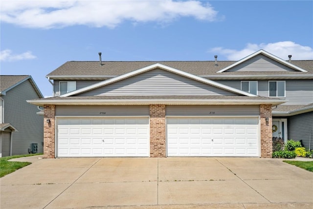 2710 Pheasant Ridge Ct, Marion, IA 52302 - traditional home featuring brick siding, driveway, and a shingled roof
