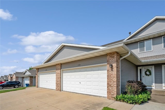 2710 Pheasant Ridge Ct, Marion, IA 52302 - view of front of house featuring brick siding, concrete driveway, and a garage