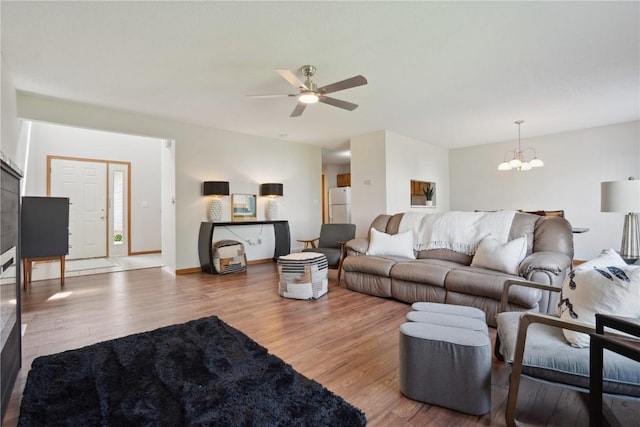 2710 Pheasant Ridge Ct, Marion, IA 52302 - living room featuring wood finished floors, a chandelier, and a ceiling fan