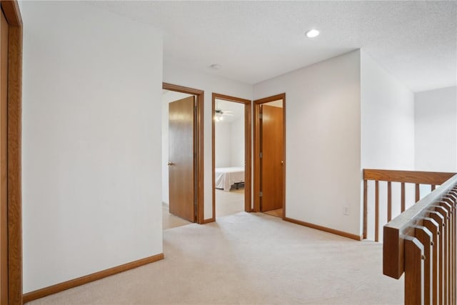 2710 Pheasant Ridge Ct, Marion, IA 52302 - corridor featuring light colored carpet, baseboards, an upstairs landing, and recessed lighting