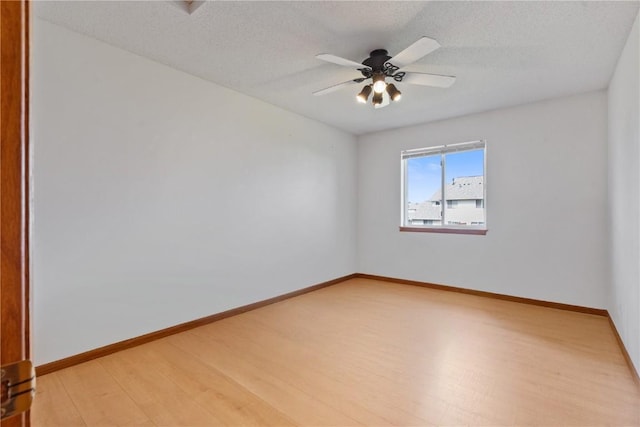 2710 Pheasant Ridge Ct, Marion, IA 52302 - unfurnished room with light wood-style flooring, ceiling fan, baseboards, and a textured ceiling
