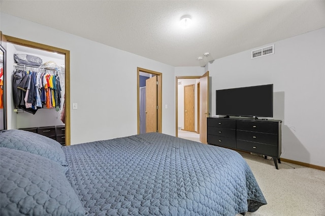 3511 E Ave NW Unit D, Cedar Rapids, IA 52405 - bedroom with a walk in closet, carpet flooring, baseboards, and a closet