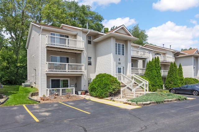 3511 E Ave NW Unit D, Cedar Rapids, IA 52405 - view of building exterior with uncovered parking and cooling unit