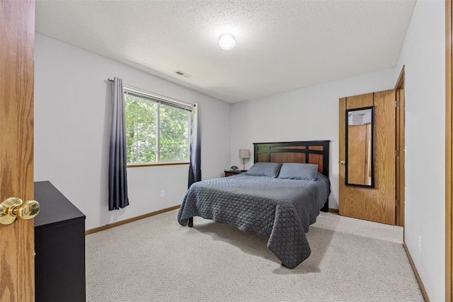 3511 E Ave NW Unit D, Cedar Rapids, IA 52405 - carpeted bedroom with baseboards and a textured ceiling