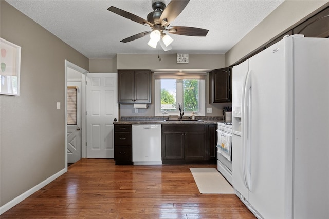 2985 4th St, Marion, IA 52302 - kitchen featuring white appliances, a sink, a ceiling fan, dark brown cabinetry, and a textured ceiling