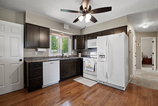 2985 4th St, Marion, IA 52302 - kitchen with white appliances, a sink, a ceiling fan, dark brown cabinets, and dark wood-style flooring